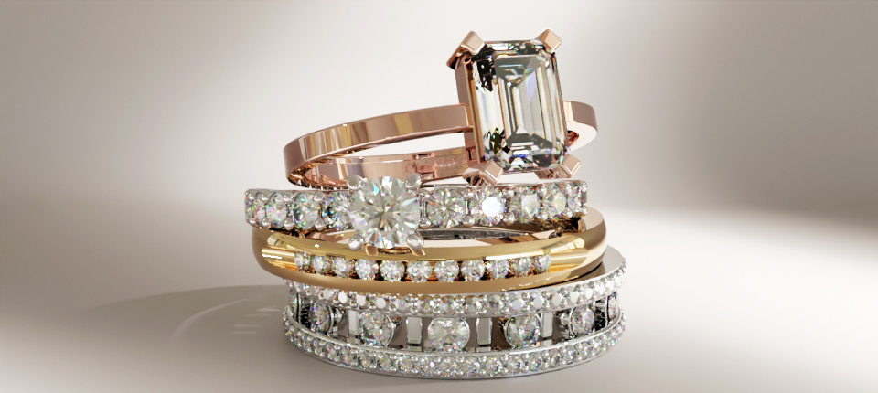 Uma pilha de anéis de ouro, platina e paládio com diamantes, mostrando seu uso em joias duráveis e luxuosas.