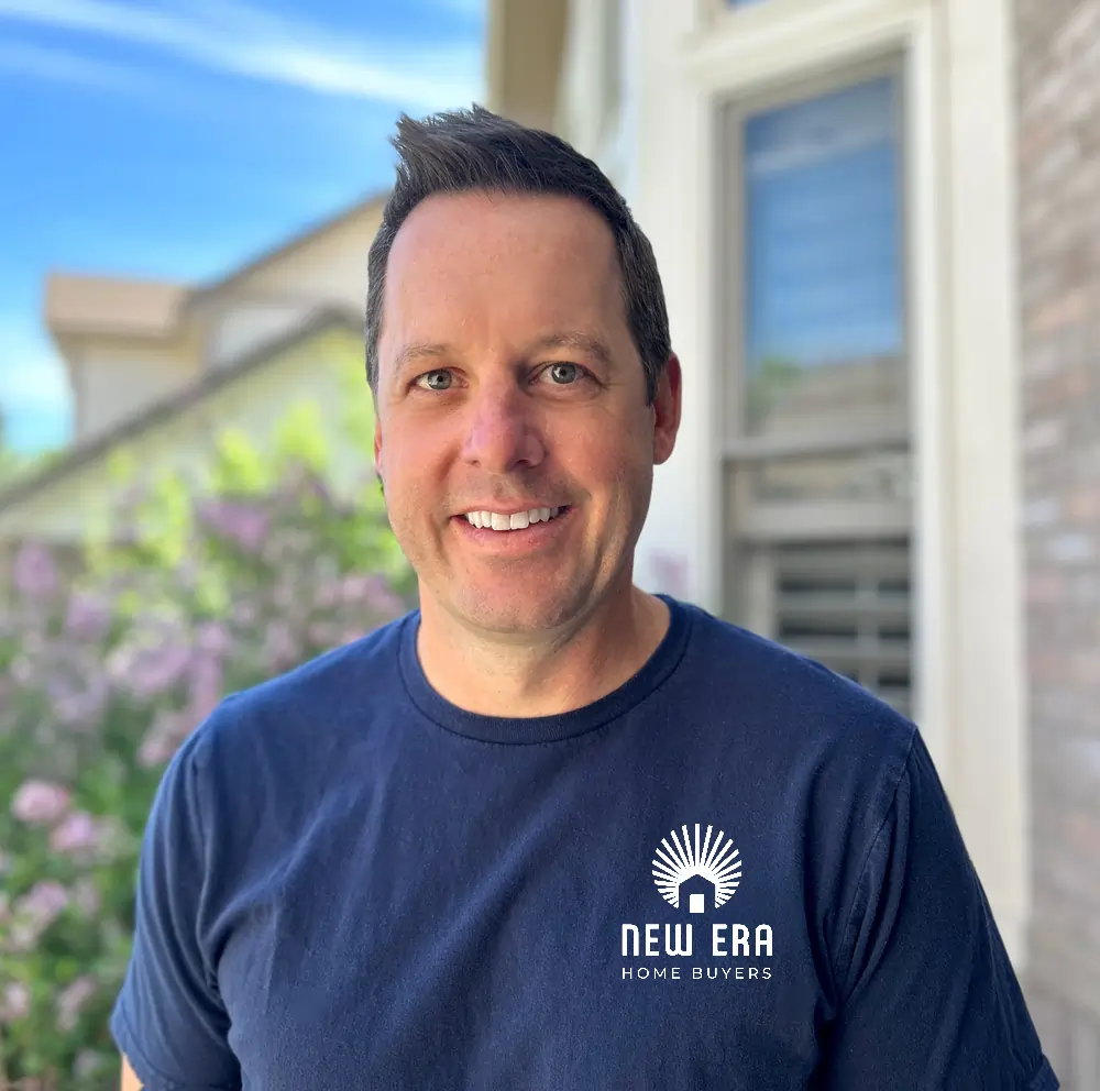 Brett Johnson owner of “New Era Home Buyers” stands outside a house, representing quick home selling services in Colorado.