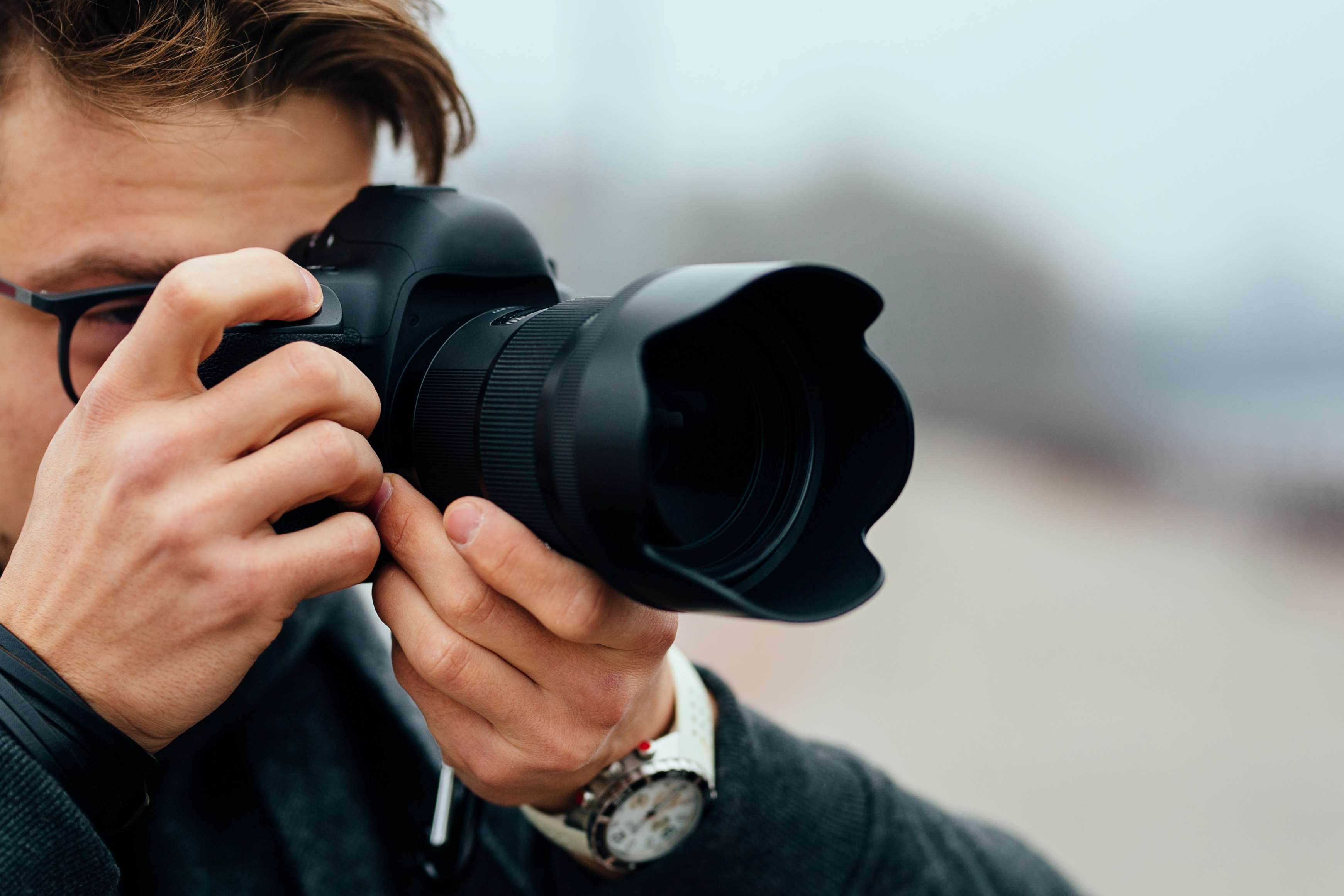 Photographer taking high-quality photos, essential for showcasing and selling old homes quickly and effectively.