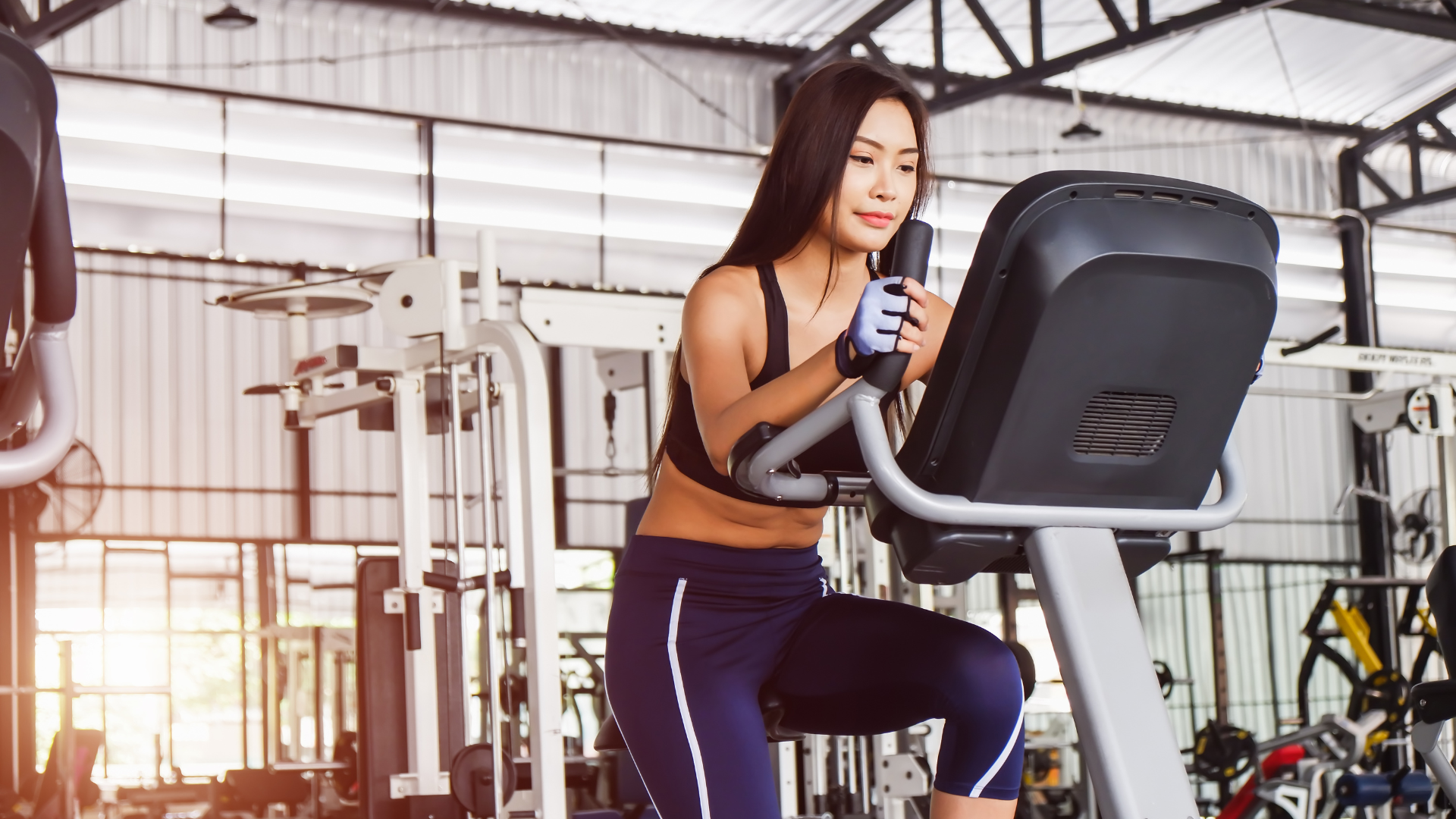 Woman using a stationary bike at a gym.