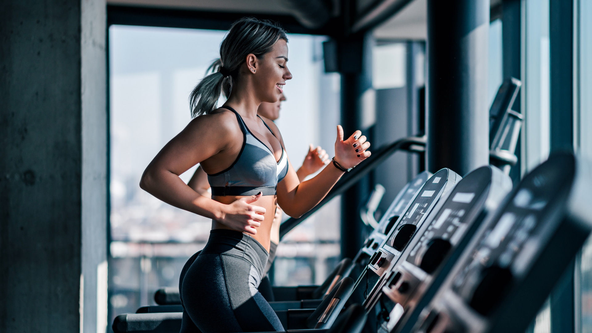 Woman exercising on treadmill in gym setting