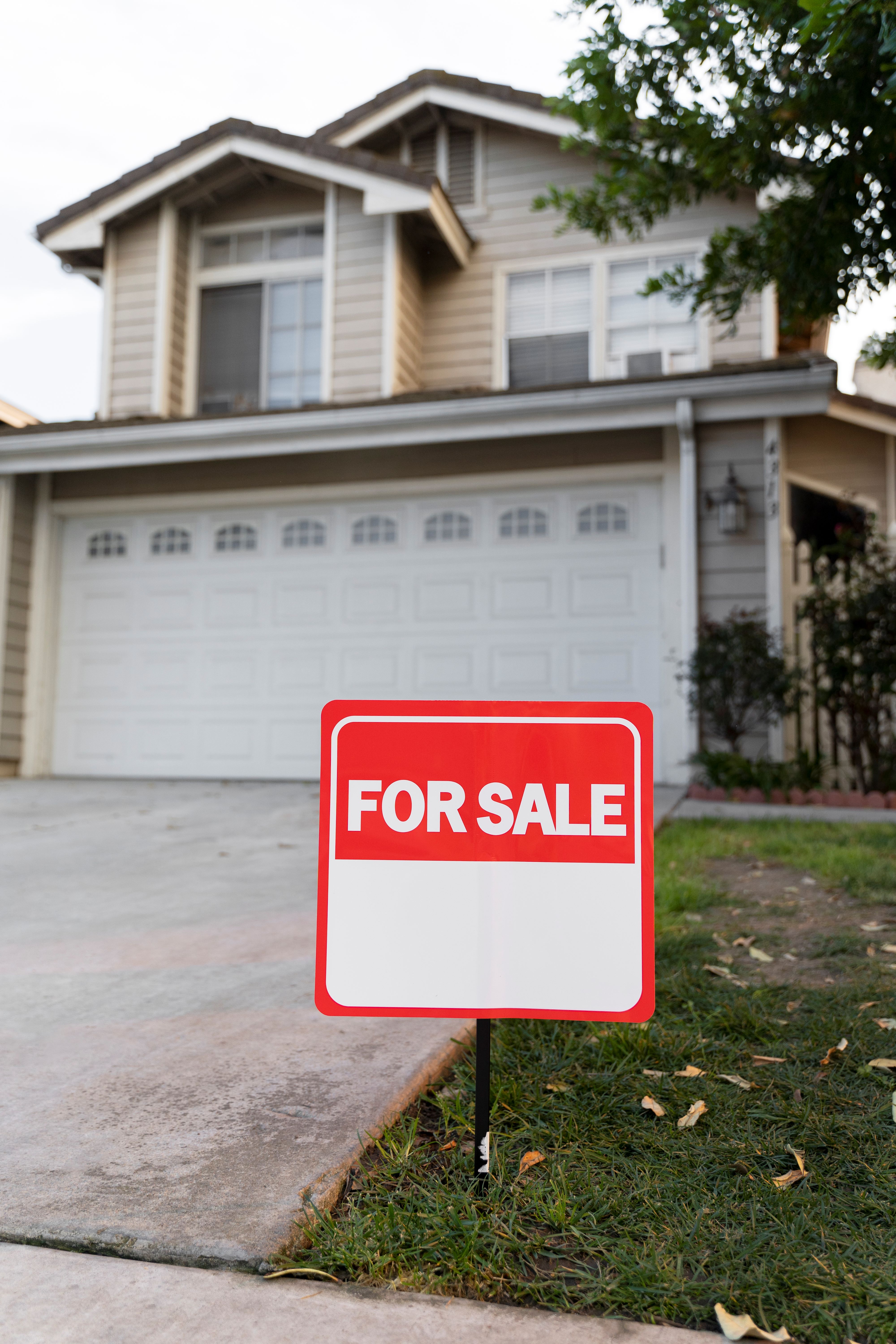 House with a “For Sale” sign in the front yard, illustrating real estate options to sell a home quickly.